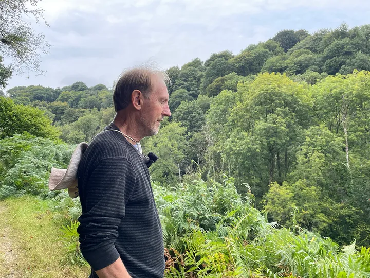 Graeme Ryan in profile looks down towards the lush green valley of the Upper Tone