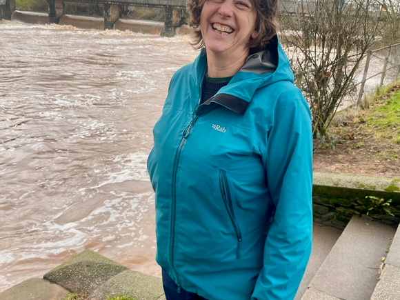 Helen Wakeham smiling at the camera in front of the River Tone near French weir