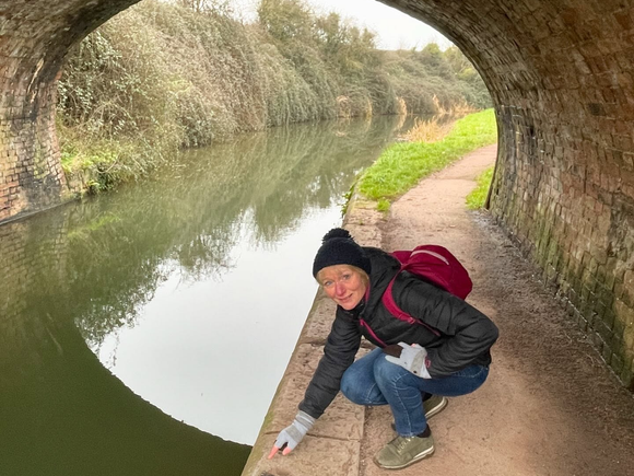 A photo of Jo Pearse of the Somerset Otter Group on the Taunton-Bridgwater canal near some otter spraint